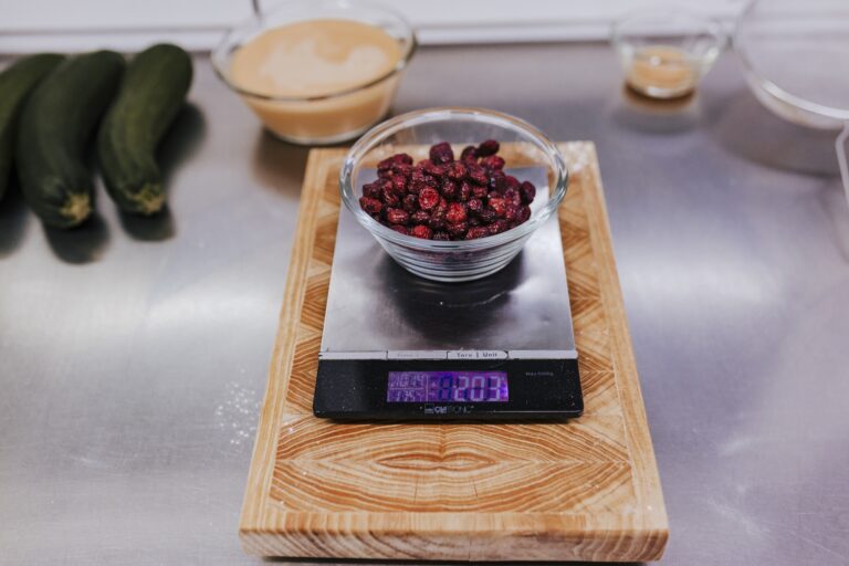 Blueberry tartlet recipe in bakery using digital kitchen scale.