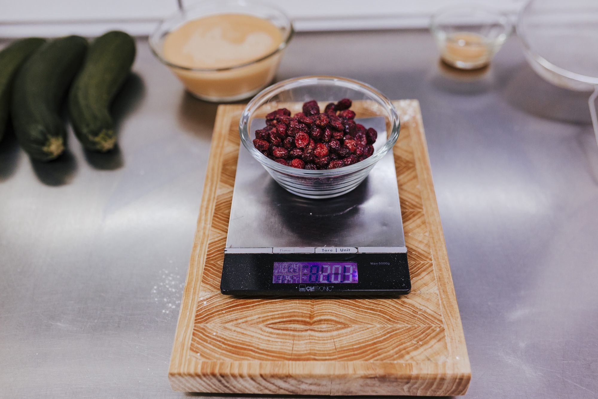Blueberry tartlet recipe in bakery using digital kitchen scale.